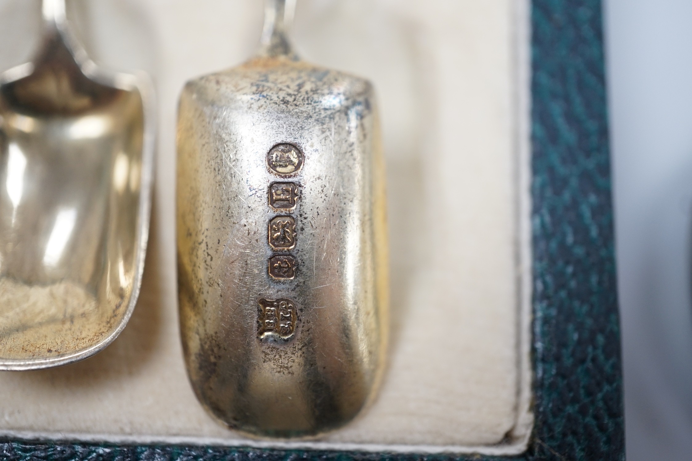 A cased set of six George V silver and polychrome enamel coffee spoons, Barker Bros. Silver Ltd, Birmingham, 1933 and two similar souvenir spoons.